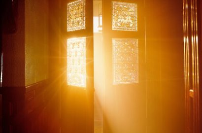 Golden light streaming through open door.