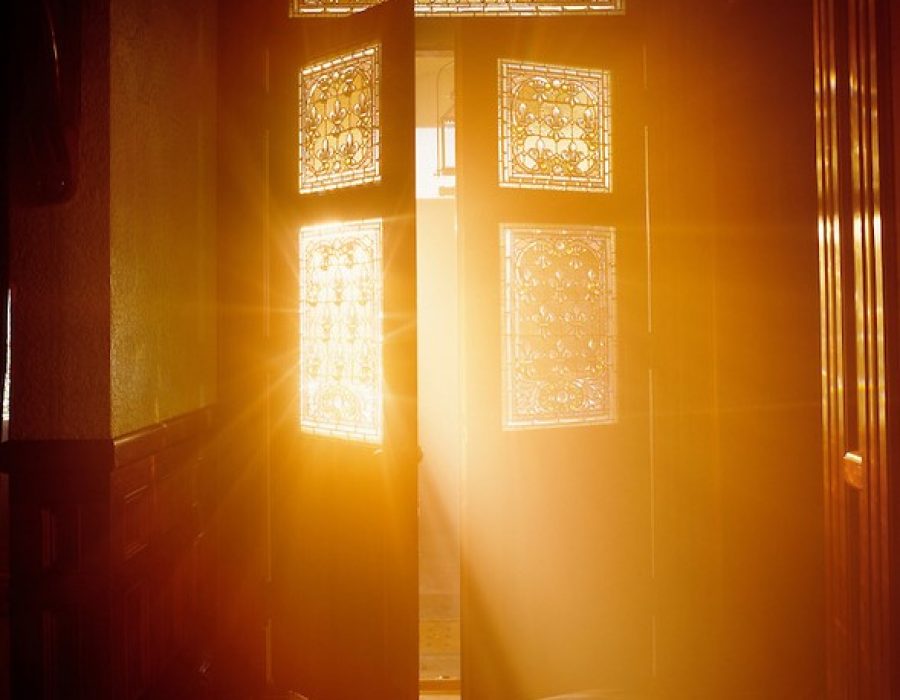 Golden light streaming through open door.
